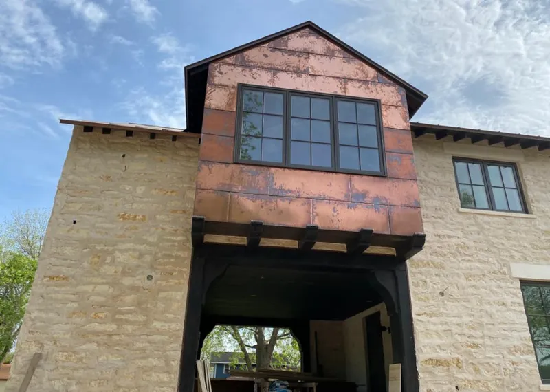 Copper metal panel facade on a stone building for Metal Roof Coating in Coachella